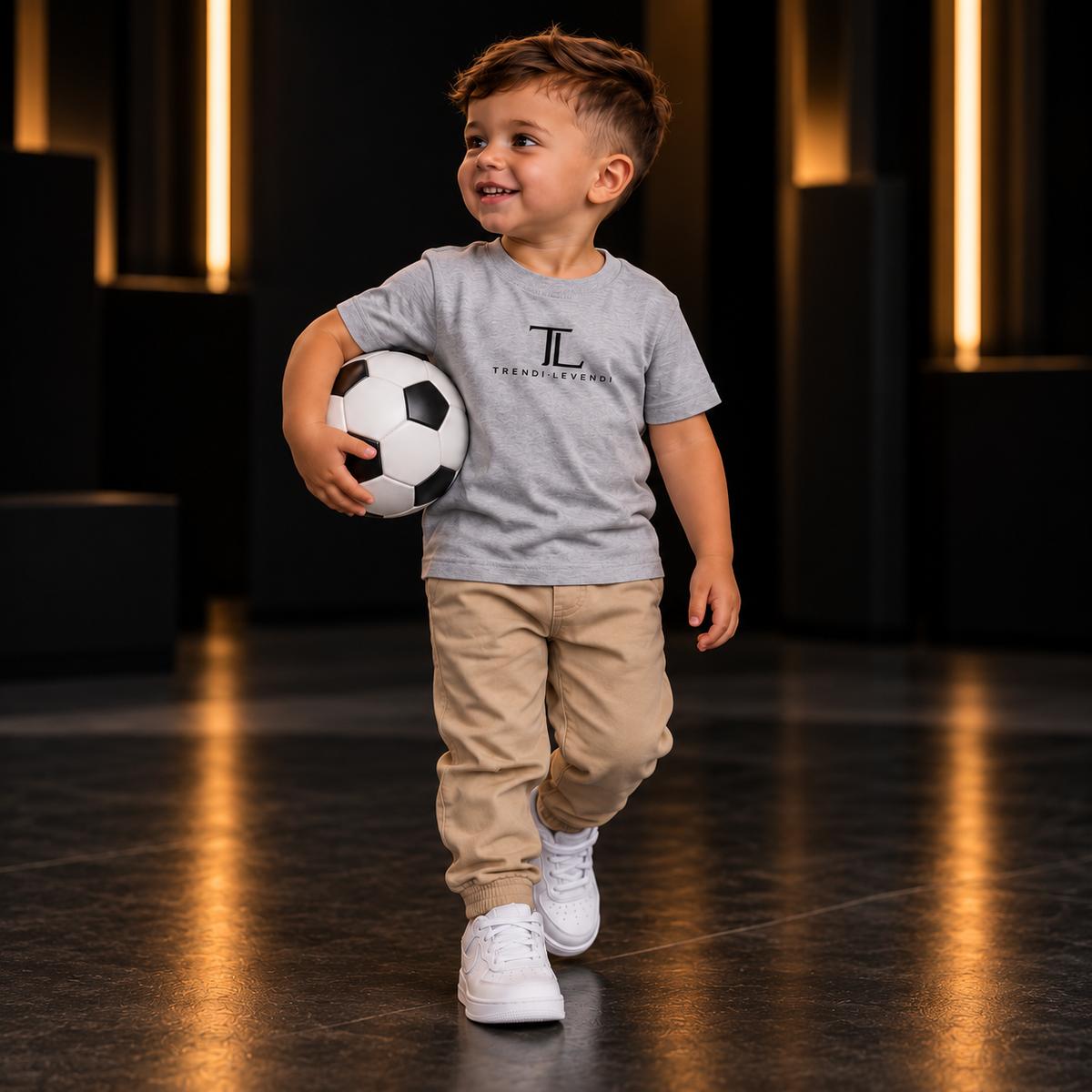 Heather Grey Trendi Levendi toddler tee, full model visible from head to shoes holding a football