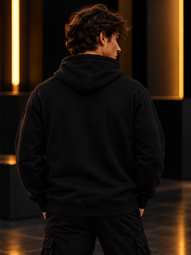 Trendi Levendi Classic Hoodie Black on male model, plain back view in dark studio