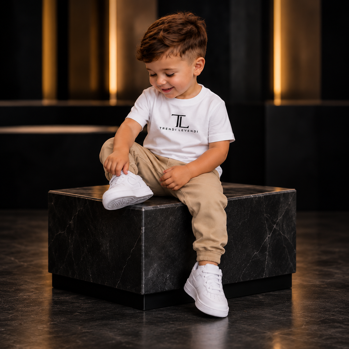 White Trendi Levendi toddler tee, full seated model visible from head to shoes